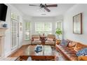 Bright living room featuring hardwood floors, a fireplace, and stylish decor at 825 Highland Ne Ln # 1116, Atlanta, GA 30306