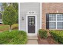 Inviting front door with decorative trim, surrounded by lush greenery and classic exterior details at 9165 Nesbit Ferry Rd # 9, Alpharetta, GA 30022