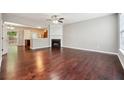 Spacious living room with hardwood floors, fireplace, and ample natural light from a large window at 9165 Nesbit Ferry Rd # 9, Alpharetta, GA 30022