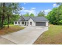 Charming craftsman-style home with white siding, black trim, and a long driveway at 110 Beaver Pointe, Villa Rica, GA 30180