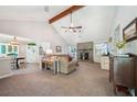 Spacious living room with vaulted ceilings, a ceiling fan, and a stone fireplace at 19 Margrit Ct, Stockbridge, GA 30281