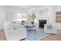 Cozy living room featuring a fireplace, a comfortable seating arrangement, and large bright windows at 3316 Stillwood Ln, Atlanta, GA 30354