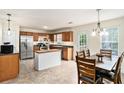 Well-lit kitchen and dining area with stainless steel appliances and an inviting dining table at 35 Kendall Ln, Covington, GA 30014