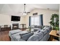 Bright and airy living room featuring a cozy fireplace, plush sectional sofa, and hardwood flooring at 35 Kendall Ln, Covington, GA 30014