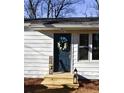 Close-up of a stylish front door with a wreath and a wooden porch at 3601 Orchard Cir, Decatur, GA 30032