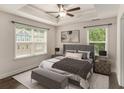 Comfortable bedroom showcasing tray ceilings, natural light, and a neutral color palette at 1624 Venture Point Way, Decatur, GA 30032