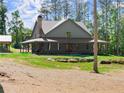 Inviting home with covered porch, stone chimney, and a well-maintained yard at 3805 Carder Ln, Cumming, GA 30028