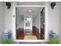 Elegant entryway featuring wood floors, a stylish mirror, and a glimpse of the staircase leading to the upper level at 4550 Lois Se St, Smyrna, GA 30080