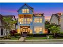 Charming three-story residence with dual balconies, enhanced by lush landscaping and inviting facade at 4550 Lois Se St, Smyrna, GA 30080