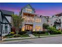 Stunning three-story home showcasing a welcoming entrance, charming balcony, and a rooftop terrace with beautiful views at 4550 Lois Se St, Smyrna, GA 30080