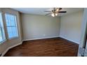 Bright and spacious bedroom with hardwood floors, a ceiling fan, and large windows at 6231 Waterton Way, Lithonia, GA 30058