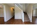 Inviting entryway with hardwood floors and a staircase with white railings at 6231 Waterton Way, Lithonia, GA 30058