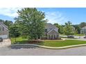 View of a brick two-story home with a green lawn and a two-car garage at 2023 Arbor Springs Way, Buford, GA 30519
