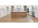 Bright kitchen with a central island, white cabinets, and modern appliances at 2719 Byess Ct, Marietta, GA 30064