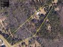 Aerial view showcasing the expansive 47+ acre lot surrounded by dense woods at 5618 Highway 212, Covington, GA 30016
