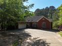 This is a charming red brick home with an attached garage and concrete driveway at 5618 Highway 212, Covington, GA 30016