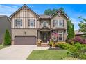 Charming two-story home featuring manicured lawn, two-car garage, and decorative shutters, complete with beautiful landscaping at 1645 Horseshoe Creek Ln, Cumming, GA 30041