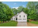 Inviting two-story home with a well-kept lawn, mature trees, and a two-car garage, perfect for Gathering living at 2986 Edenberry Nw Ln, Kennesaw, GA 30152