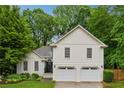 Beautiful home featuring a lush green lawn, mature trees, and a two-car garage at 2986 Edenberry Nw Ln, Kennesaw, GA 30152