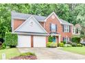 Beautiful brick home with a manicured lawn and two-car garage at 3168 Kirkwood Nw Dr, Kennesaw, GA 30144