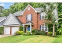 Attractive brick home with blue shutters and a well-maintained lawn at 3168 Kirkwood Nw Dr, Kennesaw, GA 30144