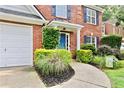 Brick home featuring a blue door and meticulous landscaping at 3168 Kirkwood Nw Dr, Kennesaw, GA 30144