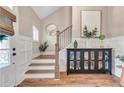 Welcoming entryway with hardwood floors, staircase, and decorative accents at 141 Alaina Rd, Canton, GA 30115