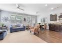 Open living room with hardwood floors, neutral carpet, and stylish furnishings under lots of natural light at 2033 Millstream Holw, Conyers, GA 30012
