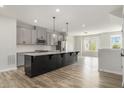 Island kitchen with grey cabinets, stainless appliances and quartz countertops at 387 Skylar Se Way, Atlanta, GA 30315