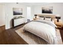 Bright staged bedroom with a large bed and modern decor at 53 Monet Nw Ct, Atlanta, GA 30327
