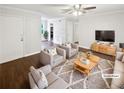 Staged living room featuring hardwood floors, plush seating, and natural light at 53 Monet Nw Ct, Atlanta, GA 30327