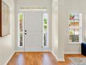 Bright foyer with hardwood floors, white door and sidelight windows at 229 Brookview Pl, Woodstock, GA 30188