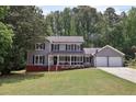 Charming two-story home with gray siding, black shutters, and a well-manicured front lawn at 4261 Vineyard Trl, Snellville, GA 30039