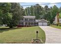 Charming two-story home with gray siding, black shutters, and a well-manicured front lawn at 4261 Vineyard Trl, Snellville, GA 30039