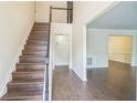 Spacious foyer featuring wood staircase and flooring at 5320 Taylor Rd, Alpharetta, GA 30022