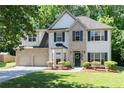Inviting two-story house with brick accents, a two-car garage, and a green front lawn at 2412 Wingfield Dr, Austell, GA 30106