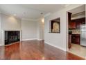 Spacious living room with hardwood floors, fireplace, and kitchen pass-through at 2161 Peachtree Rd # Apt 706, Atlanta, GA 30309