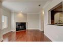 Open living space with hardwood floors, fireplace, and a pass-through to the kitchen at 2161 Peachtree Rd # Apt 706, Atlanta, GA 30309