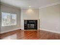 Cozy living room featuring hardwood floors, fireplace, and bright window overlooking city at 2161 Peachtree Rd # Apt 706, Atlanta, GA 30309