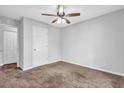 Neutral bedroom with carpet, ceiling fan, and large closet space at 3020 Meadow Glen Pass, Fairburn, GA 30213