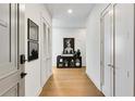 Hallway featuring hardwood floors, white walls, and stylish decor at 40 12Th Ne St # 1406, Atlanta, GA 30309
