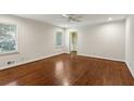 Spacious bedroom featuring hardwood floors, ceiling fan, and ample natural light at 4708 Tall Pines Nw Dr, Atlanta, GA 30327