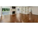Bright living room with hardwood floors, fireplace, built-in shelves, and a screened porch at 4708 Tall Pines Nw Dr, Atlanta, GA 30327