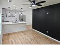 Open-concept living area featuring hardwood floors, a modern ceiling fan, and an adjacent kitchen at 775 Lee Andrews Se Ave, Atlanta, GA 30315