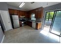 Features stainless steel appliances, wood cabinets, and sliding glass door to outdoor area at 1310 Muirforest Way, Stone Mountain, GA 30088