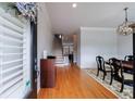 Bright entryway features hardwood floors, staircase, and dining room with stylish chandelier and decor at 359 Alderwood Ln, Atlanta, GA 30328
