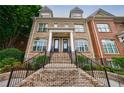 Attractive townhome exterior with brick facade, dormer windows, and landscaped entryway at 359 Alderwood Ln, Atlanta, GA 30328