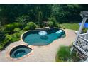 Beautiful backyard pool with a spa, patio, and lush landscaping at 3740 Duckcove Way, Cumming, GA 30041