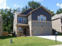 Inviting two-story home with a well-manicured lawn and a convenient two-car garage at 4630 Roseman Trl, Cumming, GA 30040