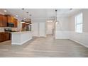 Bright eat-in kitchen with stainless steel appliances, granite countertops, and stylish pendant lighting at 4630 Roseman Trl, Cumming, GA 30040